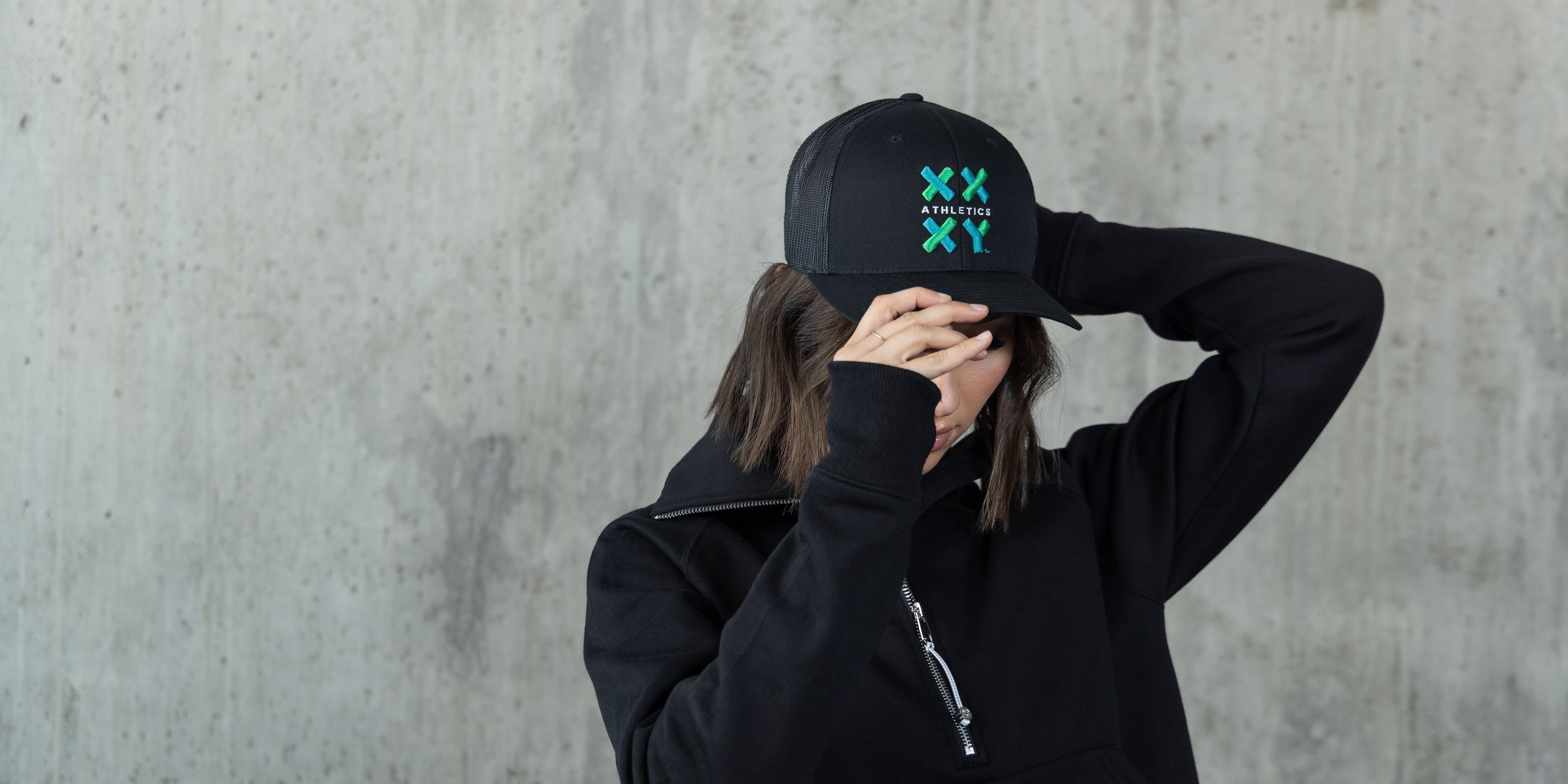 Girl wearing XX-XY Logo Trucker Hat in Black.