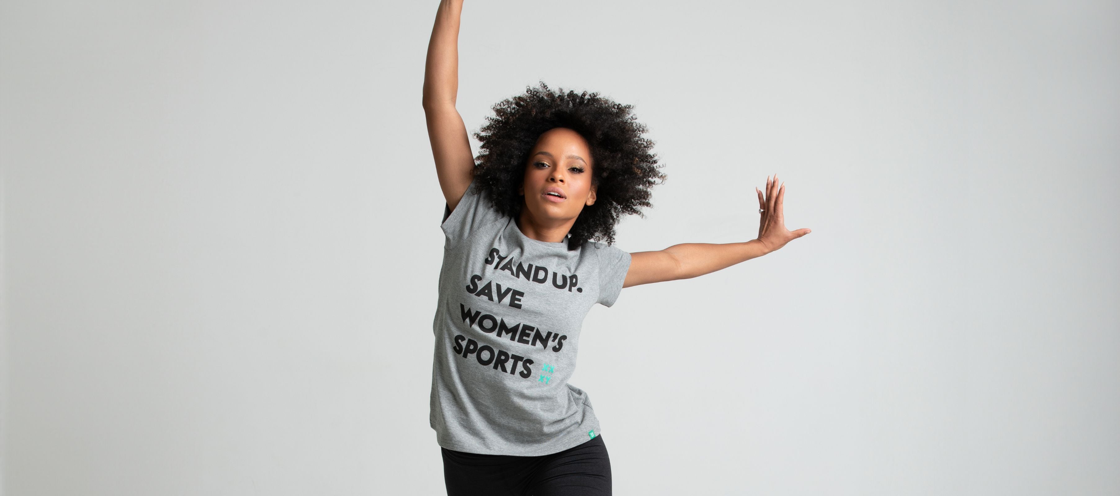 Woman at a basketball court holding a basketball while wearing her XX-XY Logo Tee.